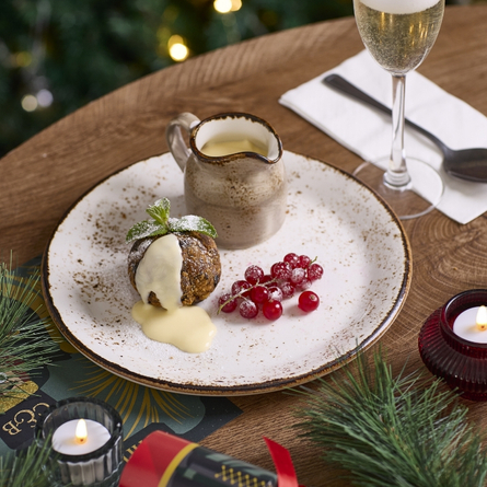 A banner showing a plated Christmas dessert sat on a table for Chef & Brewer.