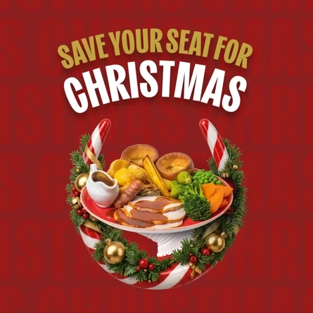 Festive Christmas dinner promotion on a red background featuring the text “Save Your Seat for Christmas”. A roast turkey dinner with gravy, roast potatoes, Yorkshire puddings, vegetables and stuffing is displayed on a serving stand, surrounded by a red and white striped Hungry Horse Horseshoe decorated with baubles and holly.