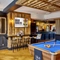 The dartboard, pool table, games machine and seating area inside The Fox and Crown.
