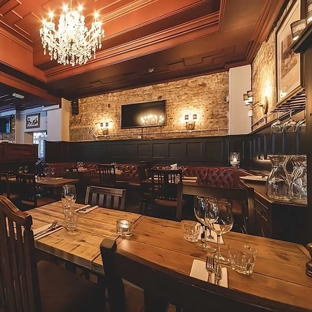 The interior restaurant seating area with TV at the Phoenix in Whitechapel.