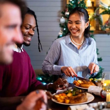 a group of people sitting at the table eating food