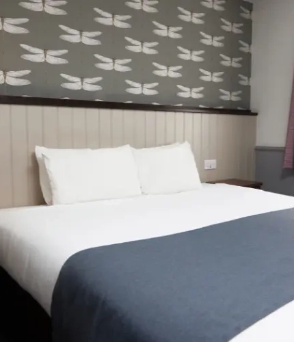 The interior king size hotel bedroom with kingsize bed at the Charnwood Arms.