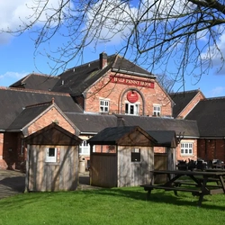 Exterior beer garden of a pub with a seating area.