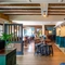 The bar and interior restaurant seating area at The Walkford, with wooden beams on the ceiling.