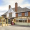 The exterior facade, signage and beer garden seating area at The Fox and Crown in Sutton-In-Ashfield.