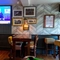 Interior dining area of a pub with a TV.