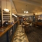 Interior dining area of a pub with a bar and a TV.