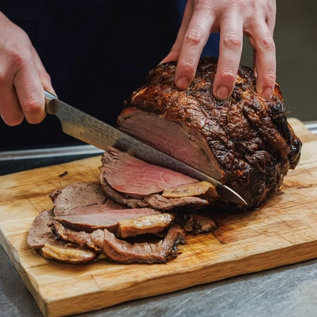 A Chef carving a joint of beef at the carvery deck at Crafted Venues.
