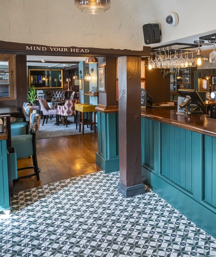 The interior bar with the restaurant seating area in the background at The Bell.