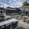 The exterior beer garden seating area with undercover and hut seating area at The Bell.