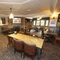 Interior dining area of a pub with a fireplace.