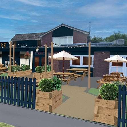 An image of the exterior facade and beer garden seating area at The White Horse.