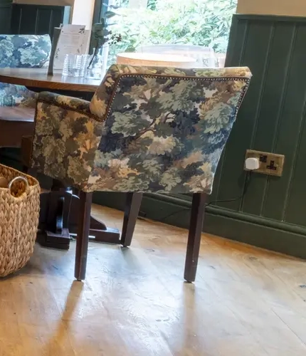 A seating area with a fireplace in The Bulls Head.