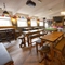 Interior dining area of a pub with a pool table and a TV.