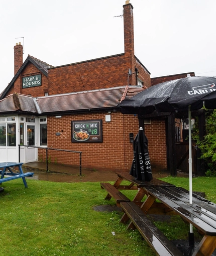 Exterior beer garden of a pub with a seating area.