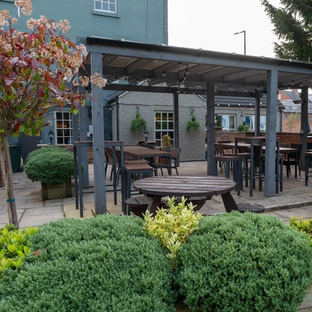 Exterior beer garden of a pub with a seating area.