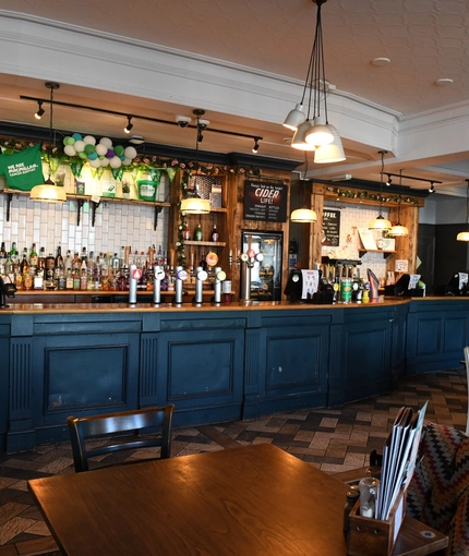 Interior dining area of a pub with a bar.