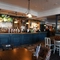 Interior dining area of a pub with a bar.