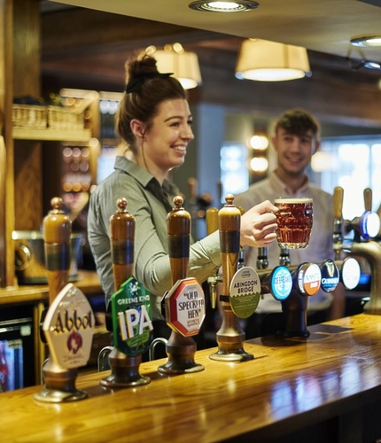 DB_C&B_People_Lifestyle_Female-Bartender-Serving-Pint_2024.jpg