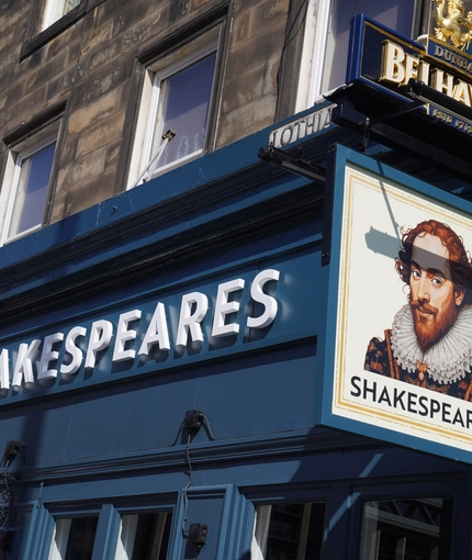 The exterior facade and signage of Shakespeares in Edinburgh.