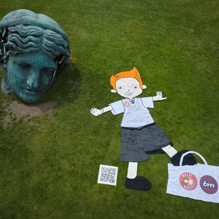Exterior Overhead showing character made from school uniform next to statue head