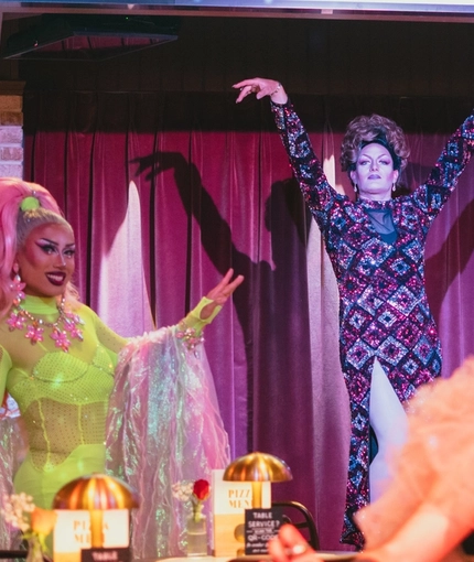 An image of 3 Drag Queens within the interior restaurant and seating area and one Drag Queen stood on the live event stage at The City Of Quebec.