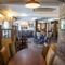 Interior dining area of a pub with a TV.