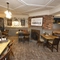 Interior dining area of a pub with a fireplace.