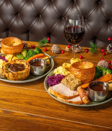 Christmas day mains of a Turkey dinner and Cheddar Leek Pie served in the restaurant at a Community Social venue.