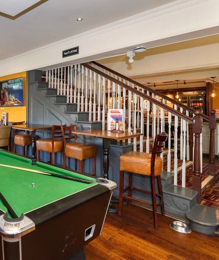 interior seating area and pool table of the pub