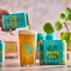 A can of Prior Life IPA being poured into a Prior Life pint glass.