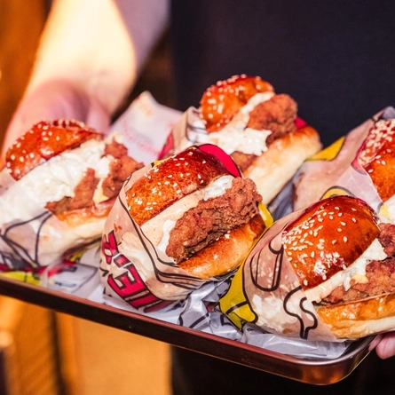 An image of a tray of burgers being delivered by a member of staff available at The Red Dog Saloon, Worlds End.