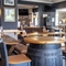 Interior dining area of a pub with a TV and gambling machines.
