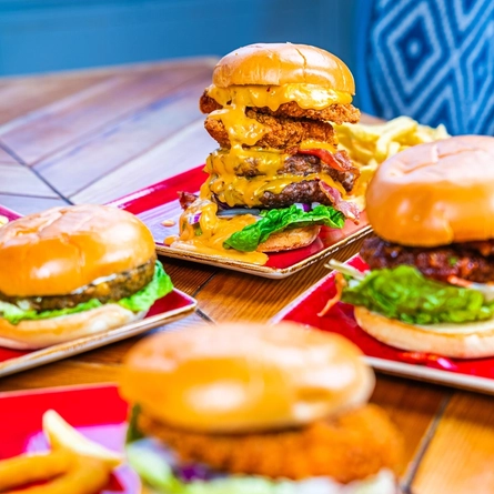 Several plates of burgers and fries.