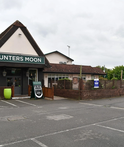 exterior facade and car park of a pub