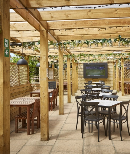 The exterior covered beer garden seating area with outdoor TV at The Yacht.