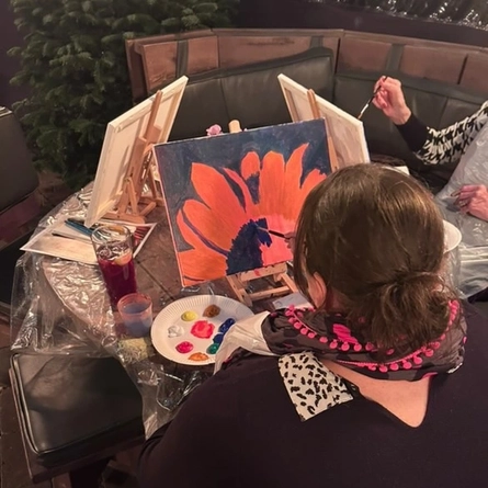 An image of 2 people sat painting to advertising a Sip & Paint What's On event at The Boat.