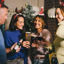 An image of 4 friends enjoying various drinks within the interior seating area at a Greene King venue.