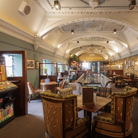 The interior restaurant seating area with electronic pub game at The Wild Boar.