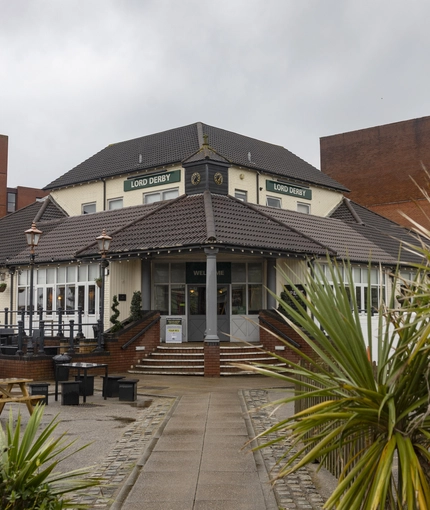 Exterior facade of a pub with a seating area.