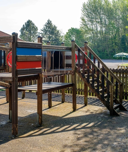 Exterior beer garden of a pub with a seating and play area.