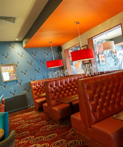 Interior dining area of a pub with a TV.