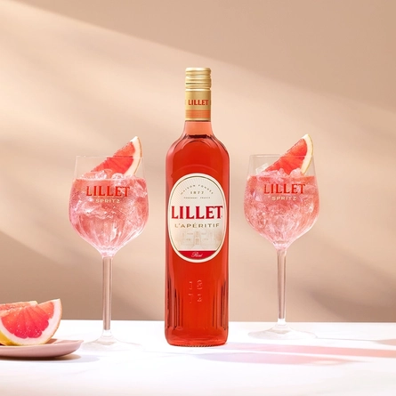 An RGB 16x9 advertising image of a bottle and glasses of Lillet Spring.