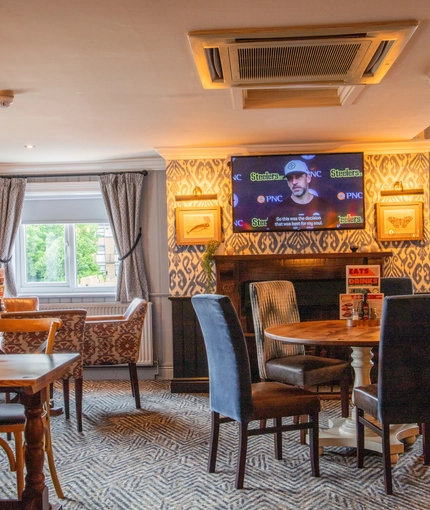 The interior restaurant and seating area with TV at the Poachers 