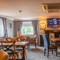 The interior restaurant and seating area with TV at the Poachers 